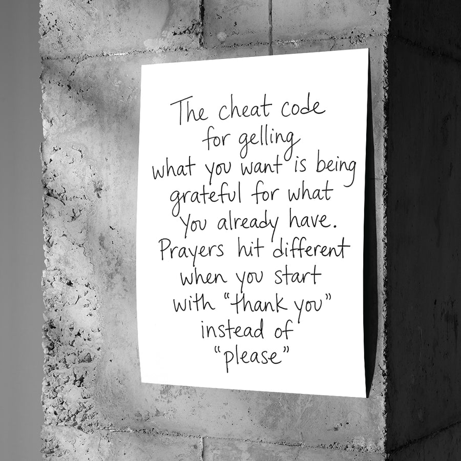 DOTCOMCANVAS Cheat Code Poster an Betonwand